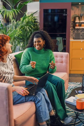 Two women talking on a couch